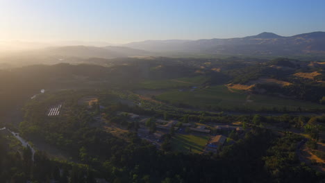 Aerial,-secluded-countryside-vineyard-in-a-mountain-valley-during-golden-hour-in-Healdsburg,-California
