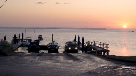 timelapse-of-a-boat-ramp-at-sunrise-as-cars-and-boats-reverse-down-the-ramp-to-launch-their-boat