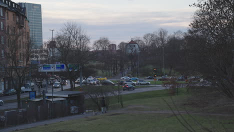 Busy-Stockholm-roundabout,-Roslagstull,-evening-traffic,-handheld,-Sweden