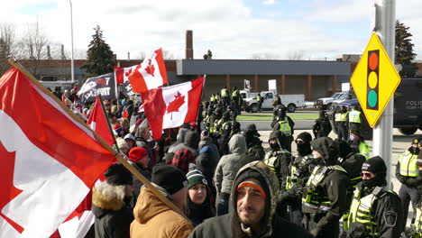 Activists-protesting-at-the-freedom-convoy-peaceful-protest,-waving-canadian-flags