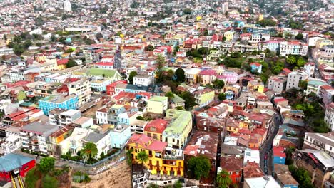 Aerial-orbit-of-neighborhood-with-colorful-houses-and-buildings-in-Concepcion-Hill,-Valparaiso,-Chile