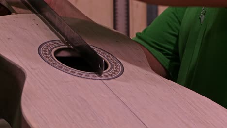 Luthier-marking-an-acoustic-guitar-he-is-making