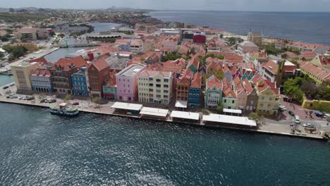 Aerial-fast-orbit-over-the-Punda-district,-Willemstad,-Curaçao