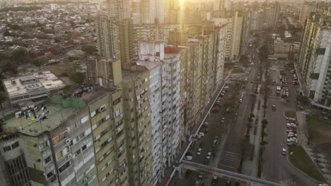 Aerial-flight-over-old-skyscraper-apartments-in-poor-district-of-Buenos-Aires-during-sunset---Barrio-Gral-Savio,Argentina