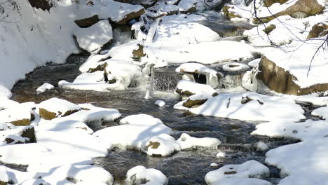 A-peaceful-shot-of-a-small-creek-winding-its-way-through-a-small-serene-winter-landscape