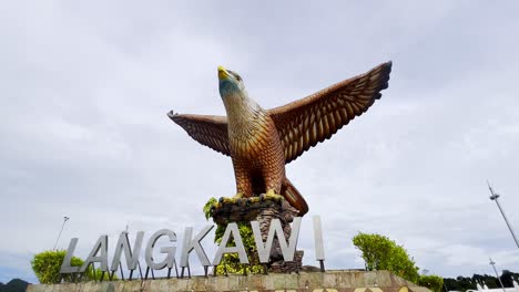A-static-shot-of-the-popular-photo-spot-featuring-a-huge-eagle-statue-perched-over-a-scenic-waterfront-plaza