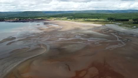 High-drone-shot-of-Waterside-Beach,-New-Brunswick-showing-coastline-and-water-tributaries