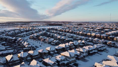 Aerial-view-of-a-suburban-community-at-sunset-in-Calgary,-Alberta-in-winter