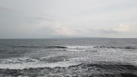 Calm-Waves-in-Bali-Silver-Sea,-Indonesian-Shore-in-Pacific-Ocean,-Quiet-Peaceful-Water-manifesting-Tranquility,-60-Fps