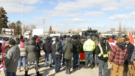 People-protest-on-blocking-road-in-Freedom-Convoy-2022-event,-Ontario,-Canada