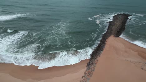 Aerial-view-of-the-ocean-and-the-waves-reaching-the-beach