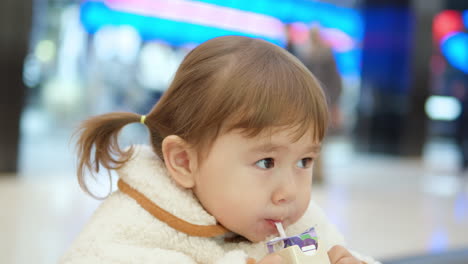 Little-Girl-Drinking-Juice-At-The-Shopping-Mall