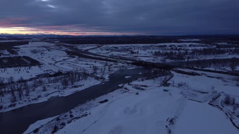 Flying-drone-over-canadian-winter-wonderland:-aerial-view-of-snowy-roads