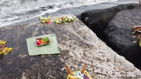 Balinese-Flower-Offerings,-Canang-Sari-at-the-Beach,-Prayer-and-Worship-Art-in-the-Bali-Sea,-Indonesia,-Hinduism,-Religious