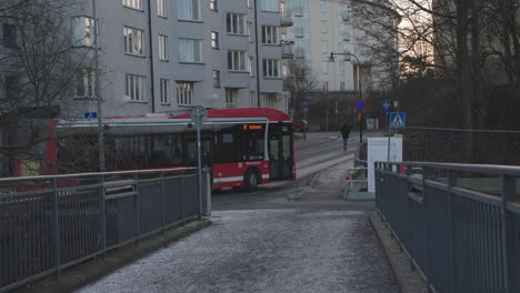 Red-public-transportation-SL-bus,-Stockholm,-Sweden,-handheld,-winter-day