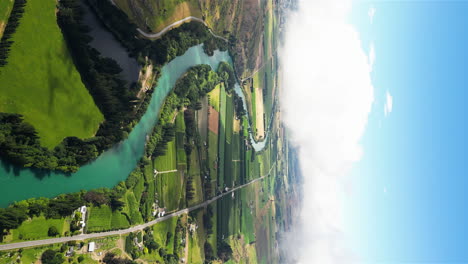 Idyllic-landscape-of-Pinders-Pond-by-Clutha-river,-New-Zealand,-aerial-vertical-view