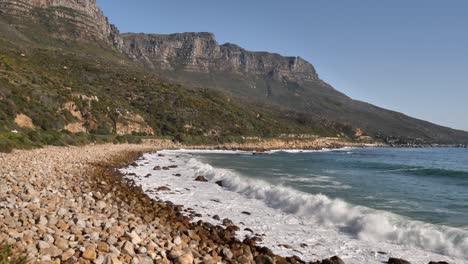 Surf-waves-break-foaming-onto-rocky-beach-in-Cape-town-South-Africa