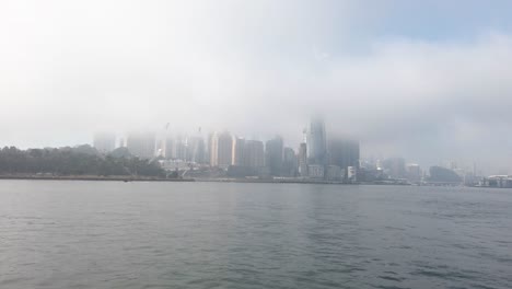 View-Of-Barangaroo-While-On-Ferry-During-A-Misty-Morning-In-Sydney,-New-South-Wales,-Australia---wide-shot