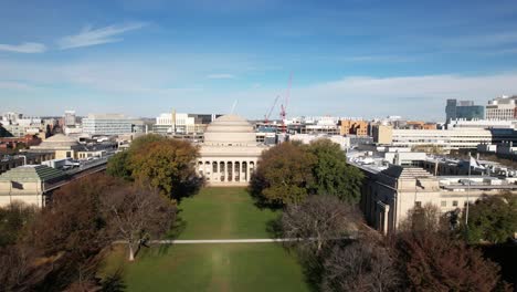 MIT-at-Killian-Court-and-Great-Dome-in-Boston-Massachusetts-Institute-of-Technology,-drone-view-on-blue-sky-afternoon