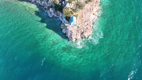 Drone-footage-over-a-small-Greek-Orthodox-church-on-the-rock-next-to-the-sea