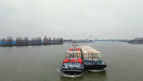 29-January-2023---Aerial-View-Off-Forward-Bow-Of-Denford-Cargo-Ship-Partnered-With-Barge-Transporting-Containers-Along-Oude-Maas
