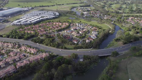 Scenic-Cheltenham-Drive-Crossing-Mudgeeraba-Creek-In-The-Suburb-Of-Robina-In-Gold-Coast,-Queensland