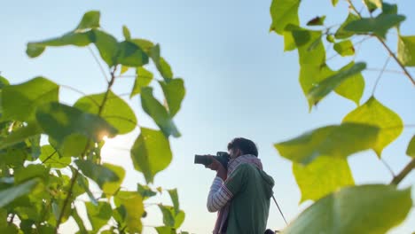 Concentrated-photographer-taking-pictures-with-long-lens-in-nature-environment