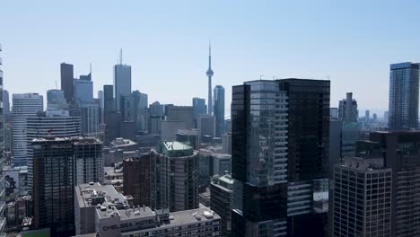 Aerial-shot-flying-between-buildings-in-downtown-Toronto-on-a-sunny-summer-day
