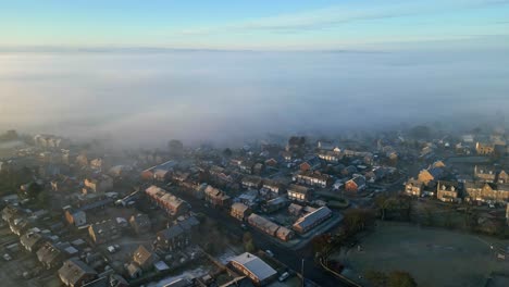 Cinematic-aerial-footage-of-a-misty-morning,-aerial-shoot-over-small-beautiful-town