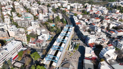 Drone-footage-of-the-metro-station-and-the-railway-tracks-in-Marousi,-a-suburb-in-the-north-of-Athens,-Greece