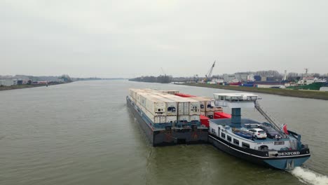 29-January-2023---Aerial-Strern-View-Of-Denford-Cargo-Ship-Partnered-With-Barge-Transporting-Containers-Along-Oude-Maas