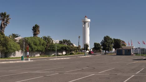 Cars-drive-to-white-Milnerton-Lighthouse-in-Cape-town,-South-Africa