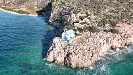 Drone-footage-of-a-small-Greek-Orthodox-church-on-the-rock-next-to-the-sea