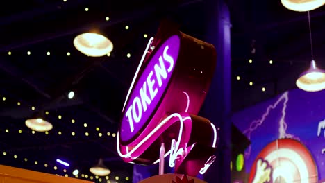 Tokens,-Game-Arcades,-Casino,-Purple-Neon-lights,-Sign-spinning,-futuristic-arcade