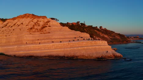 Aerial-View-Of-Scala-Dei-Turchi-Bathed-In-Orange-Sunset-Light