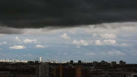 Stunning-timelapse-of-dark,-turbulent-clouds-rolling-over-the-skyline-of-Toronto,-Canada,-creating-a-dramatic-and-intense-sky