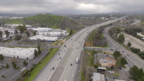 Interstate-5-by-Santa-Clarita,-California-on-an-overcast-day---aerial-flyover