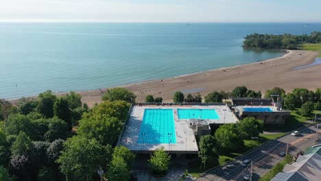 Aerial-view-orbiting-over-a-pool-and-beach-in-downtown-Toronto-in-the-summer