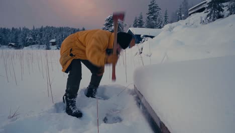 A-Guy-With-Axe-Is-Breaking-Thick-Ice-Of-A-Frozen-Lake