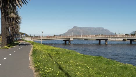 People-walk-across-Cape-town-bridge-with-Table-Mountain-background