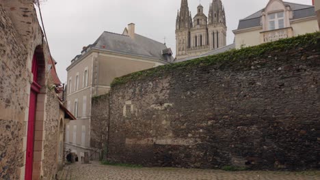 Buildings-And-Streets-In-The-Old-Town-Of-Angers-With-Main-Cathedral-In-The-Background,-France,-Maine-et-Loire---wide