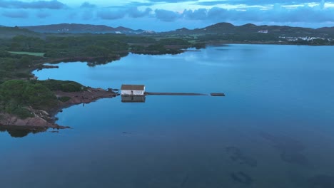 Panning-around-boat-house-in-Menorca-with-drone-slowly