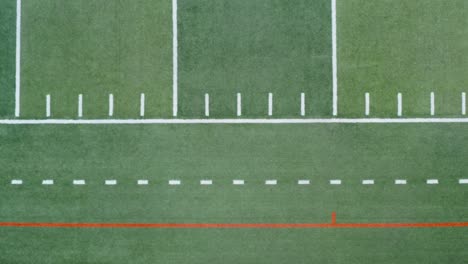 Top-down-aerial-of-yard-markings-on-American-football,-soccer-field
