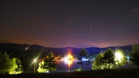 Bright-flashing-lights,-stars-over-lake-at-night-near-Varbo,-Hungary