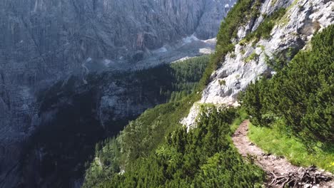 Cinematic-view-of-Dolomites-hiking-pathway-on-steep-slope,-aerial-drone-fly