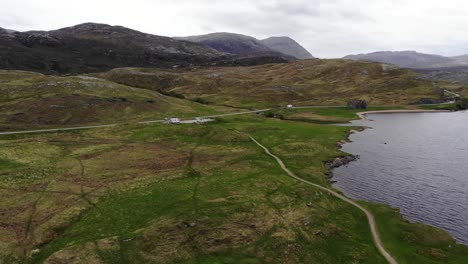 Aerial-descending-shot-from-Loch-Assynt-looking-towards-the-mountains-of-the-Scottish-Highlands