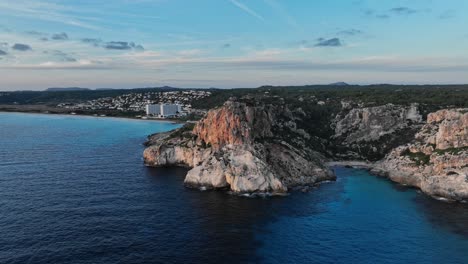 Flying-drone-over-Spanish-coastline-with-village-town-in-the-background