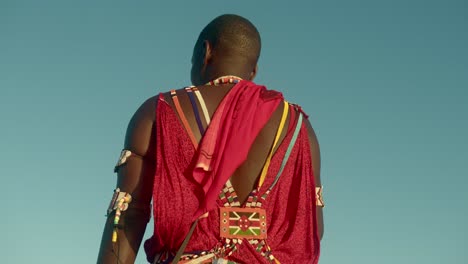 Rear-Of-A-Young-Male-Masai-Warrior-Wearing-Traditional-Clothing-In-A-Tribe-In-Kenya