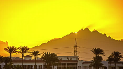 Albatros-Beach-Hotel-Time-Lapse-with-Sun-Rising-Behind-Mountain,-Hurghada-Egypt