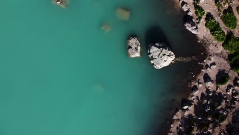 Magical-blue-color-of-Lake-Serapis,-Dolomites-Italy,-aerial-top-down-view